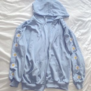 Light blue zip up jacket with daisies on sleeves